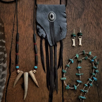 Hand constructed artisan jewelry using natural stones, bones, leather, and sterling silver, with a selection of hand sewn leather bags and more.